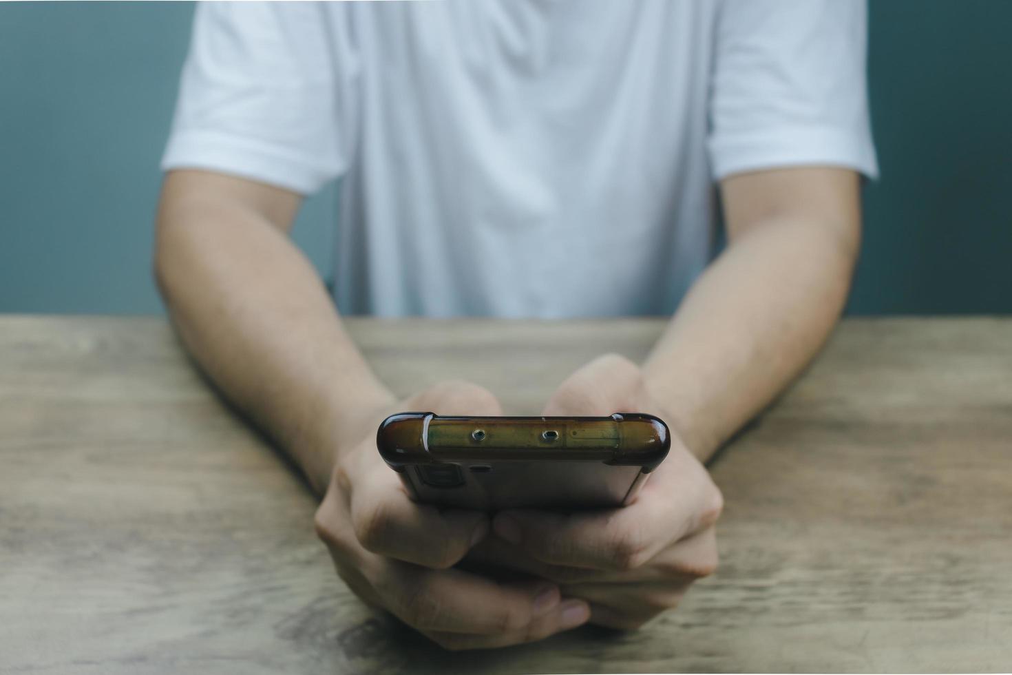 Social media technology concept, men's hands using smartphones to login social media, work from home or do online marketing. business and finance photo