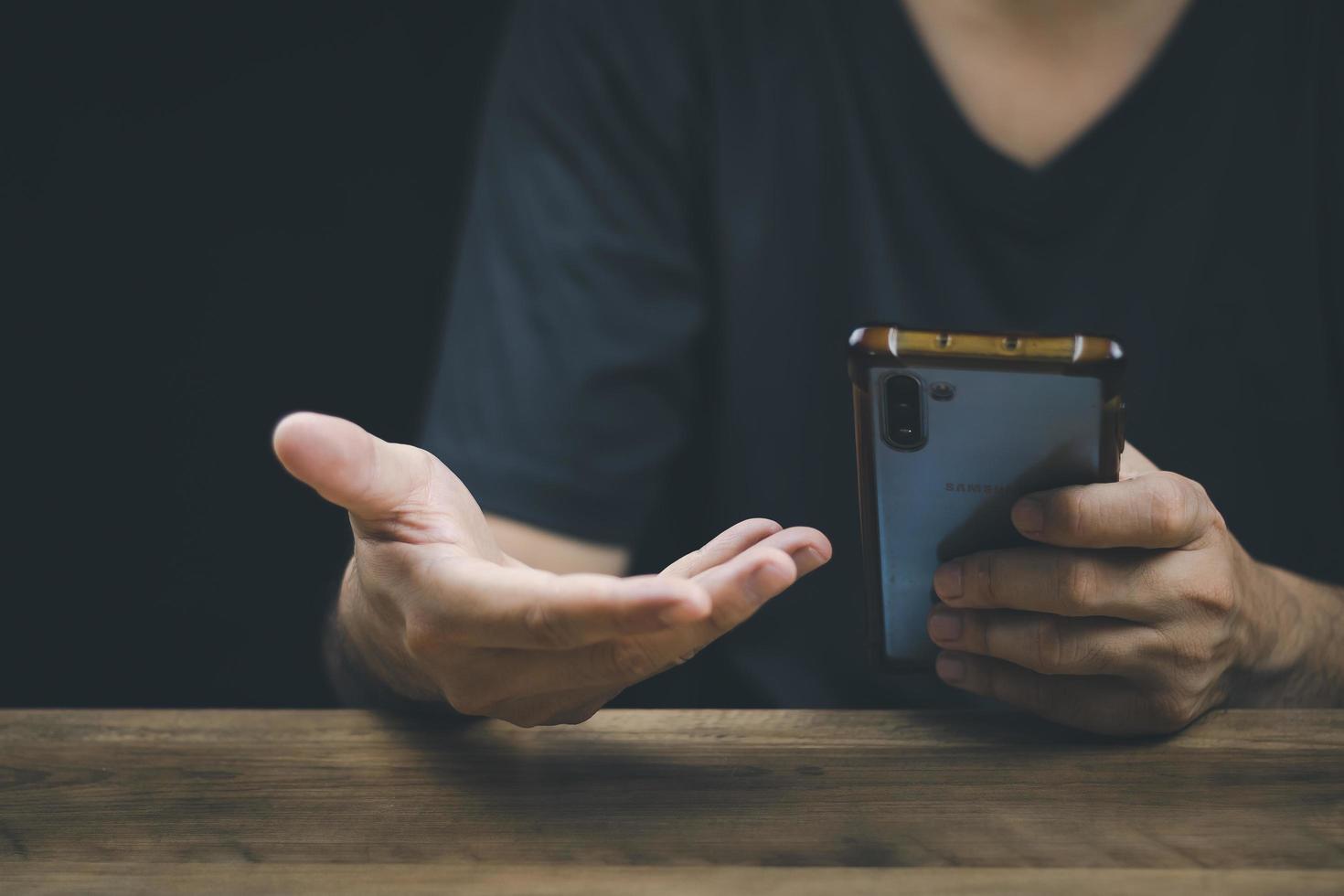 Social media technology concept, men's hands using smartphones to login social media, work from home or do online marketing. business and finance photo