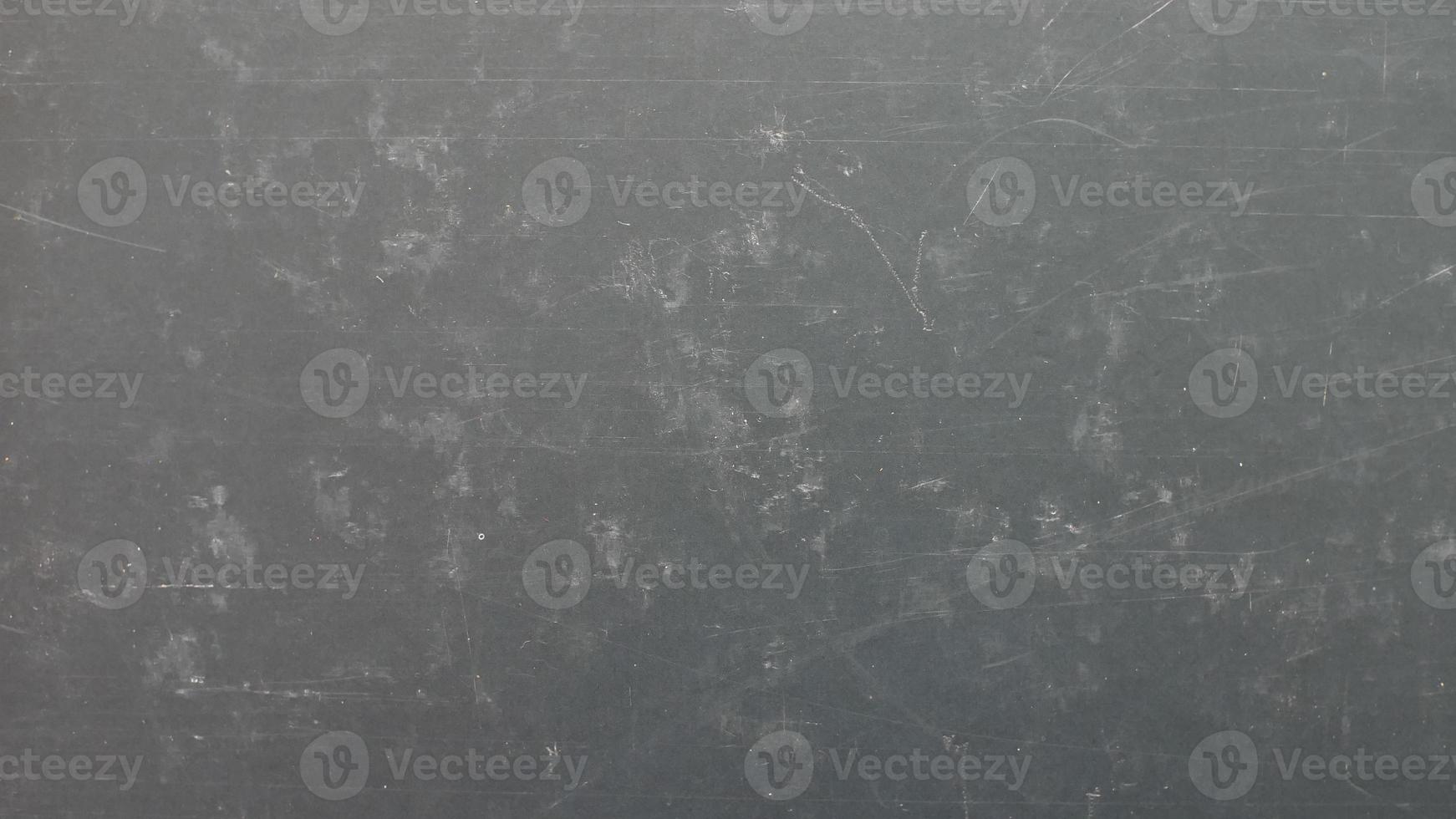 black matte texture of scratched cardboard surface photo