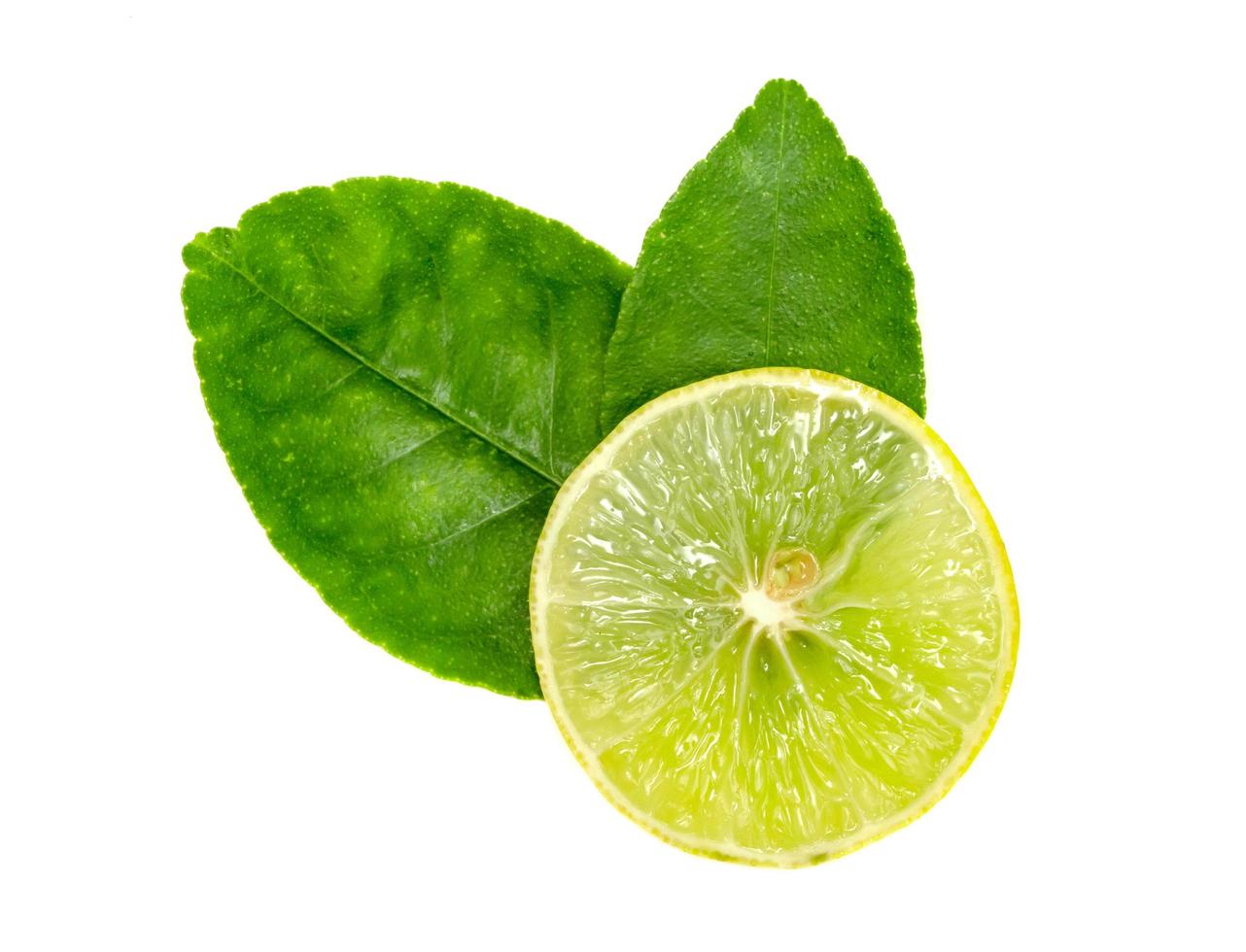Yellow lemon slice and leaves isolated on white background photo