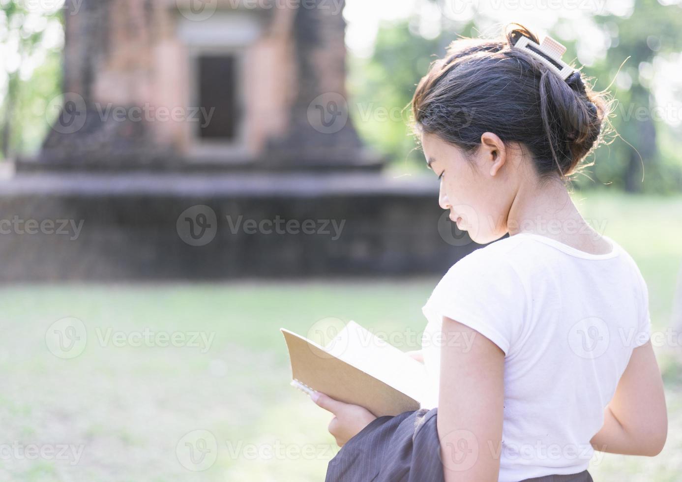 Slim teenage girl looking amazing scenery Explore ancient sites. photo