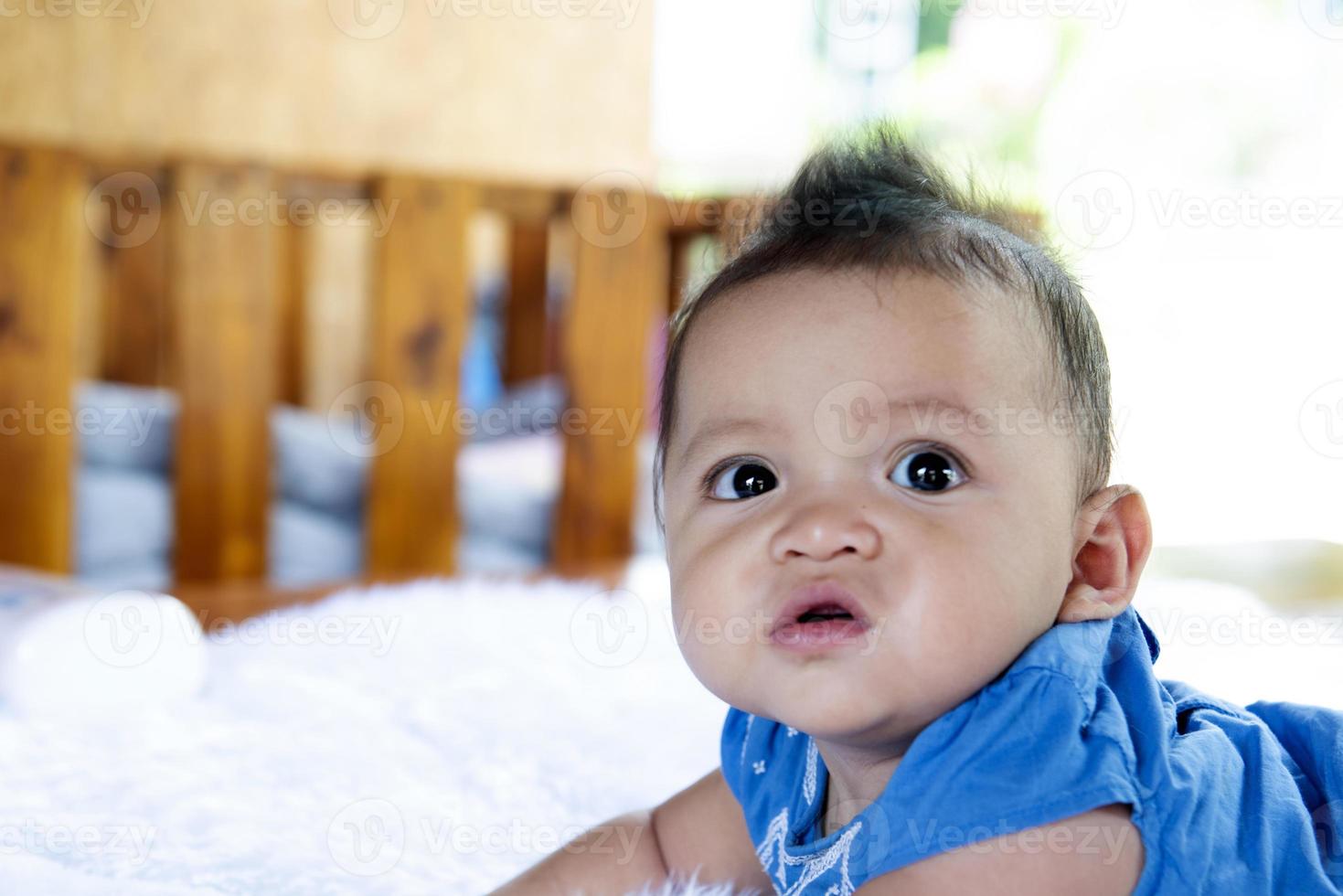 A Beautiful 6 Month Old Baby With Big Eyes Lies On The Bed 10123621 a-beautiful-6-month-old-baby-with-big-eyes-lies-on-the-bed-10123621
