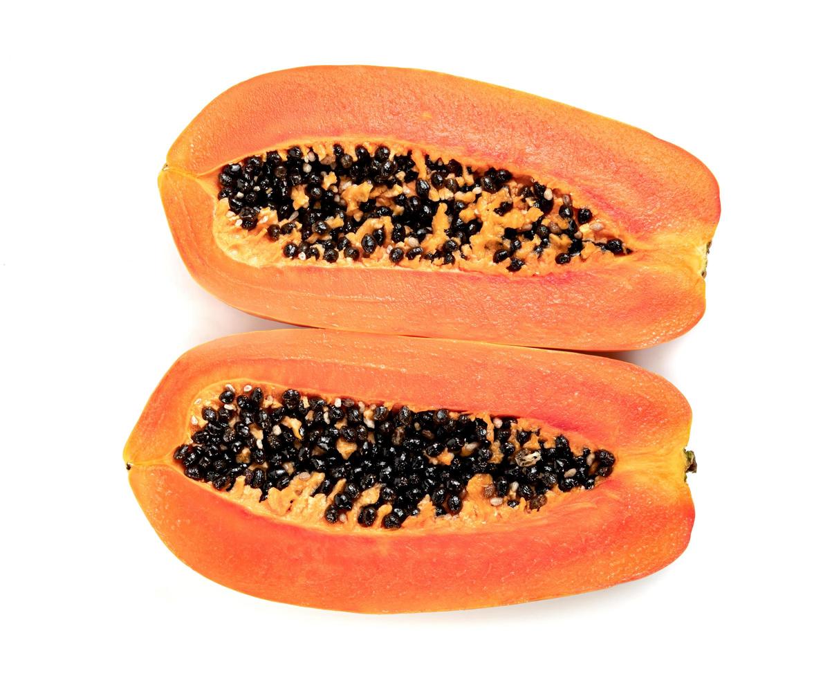 Ripe papaya slice isolated on white background photo