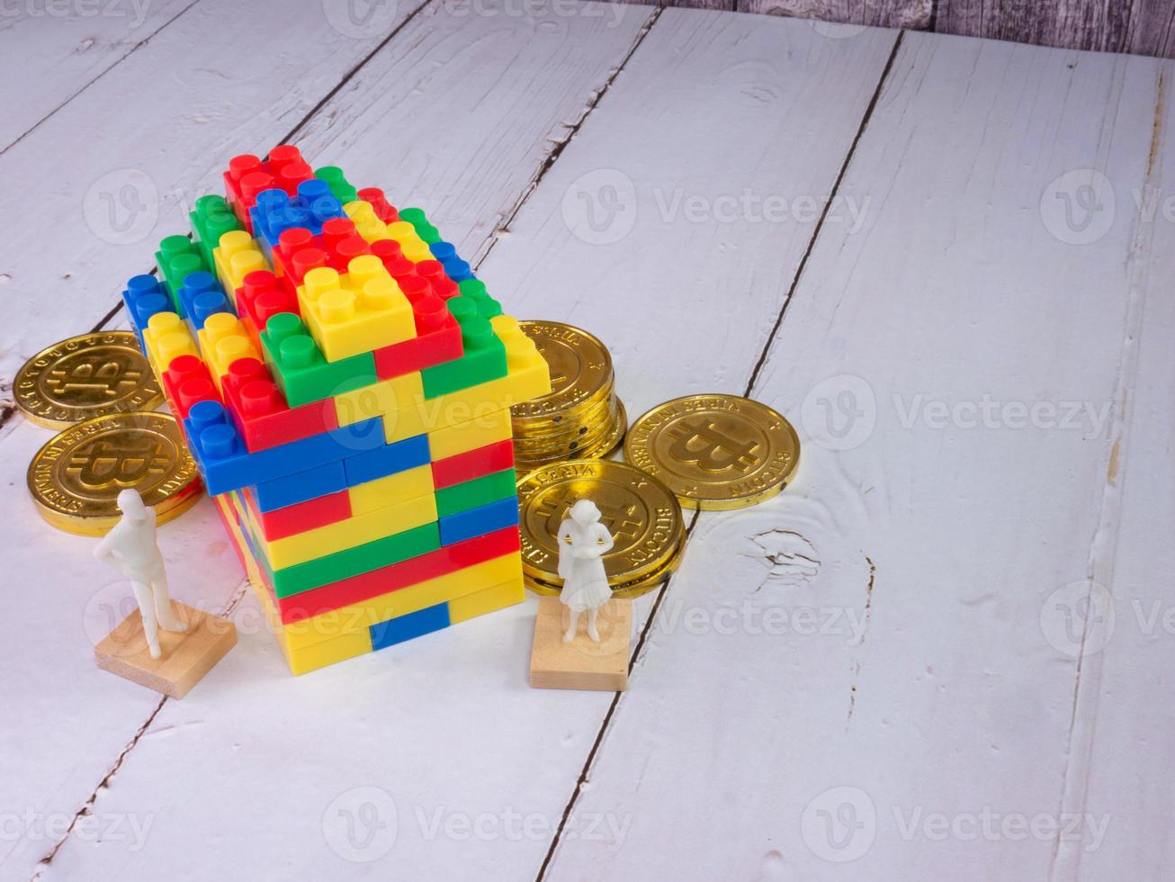 home multicolour toy brick and gold coins for kid or property business concept photo