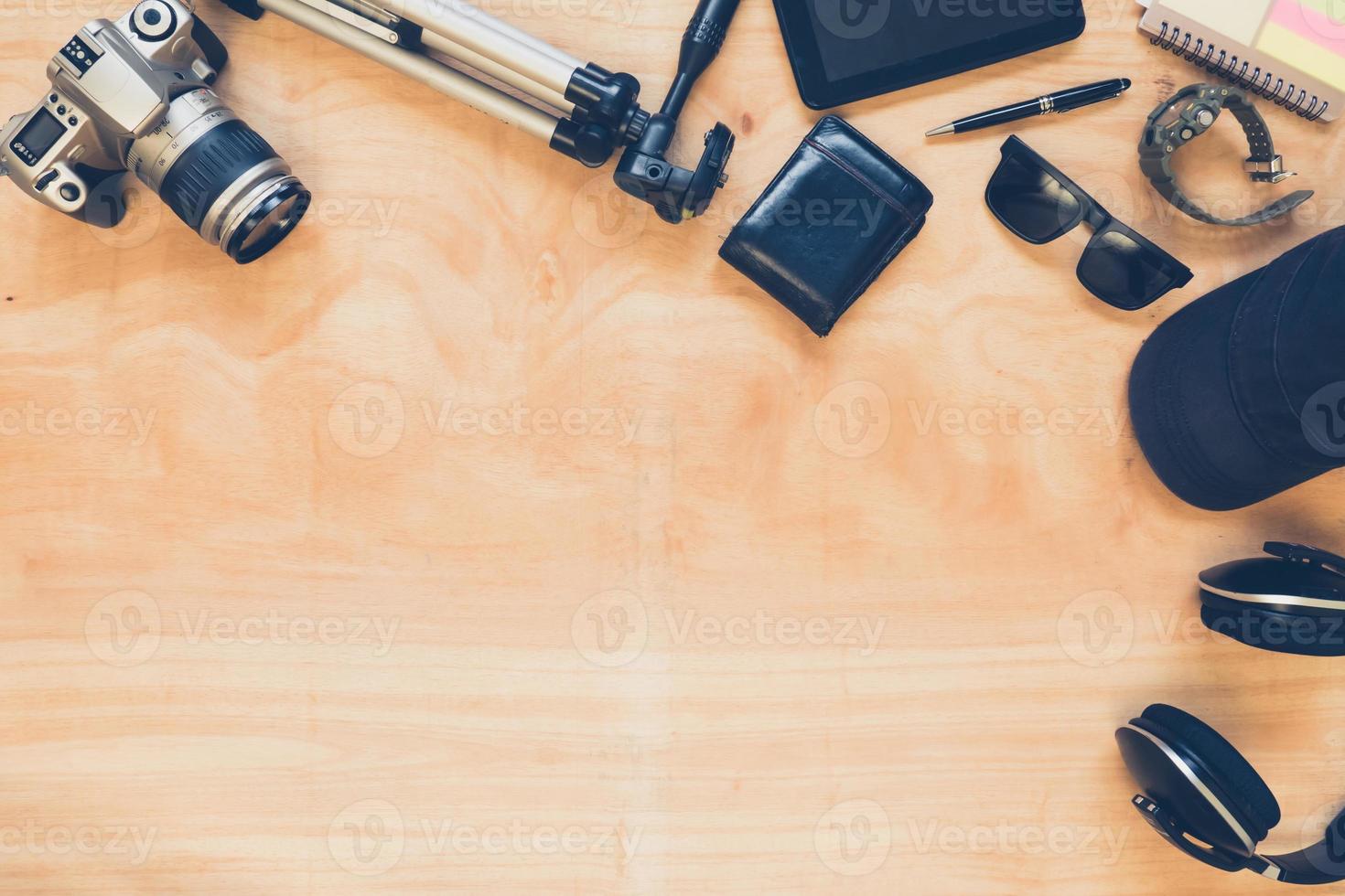 Top view of clothing and diverse personal accessory on the wooden table background. photo