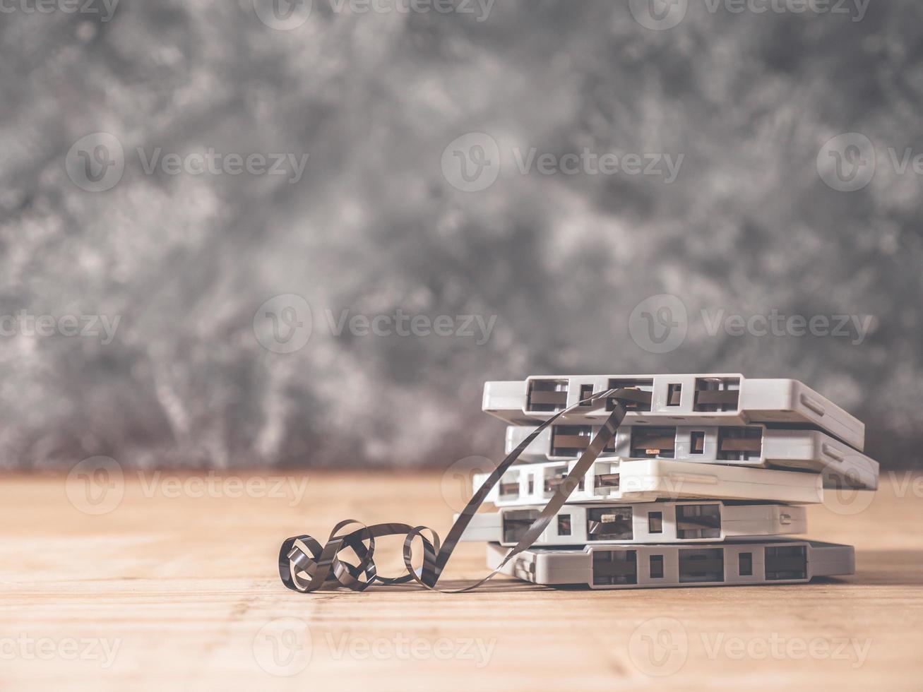 Cassette tapes over wooden table with grunge background.retro filter. photo