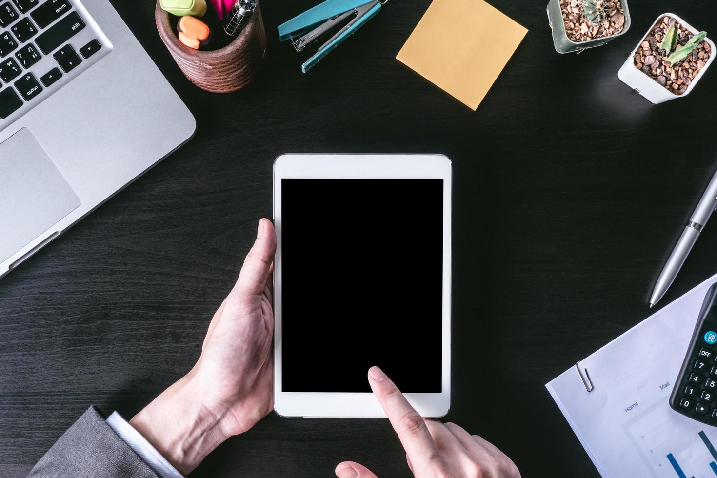 Top view of Businessman using tablet on the office desk. photo