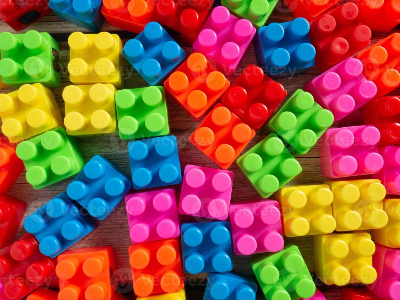 Toy brick on wood table photo