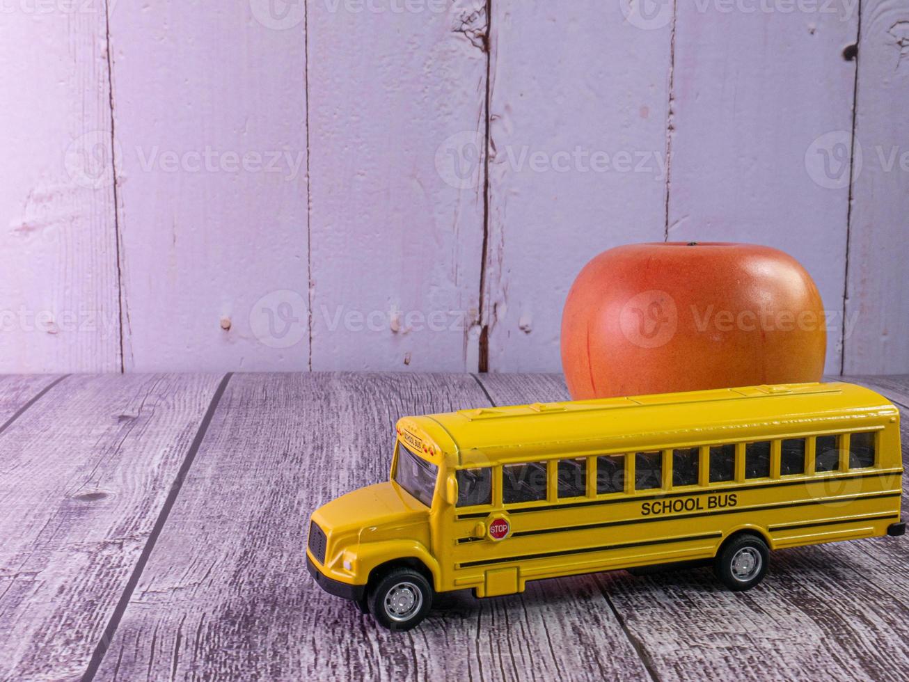 school bus on wood table for education concept photo