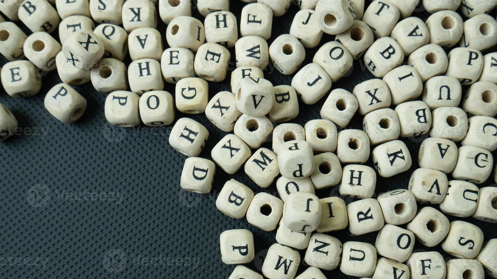 The alphabet wood cube on black background  for  education concept photo