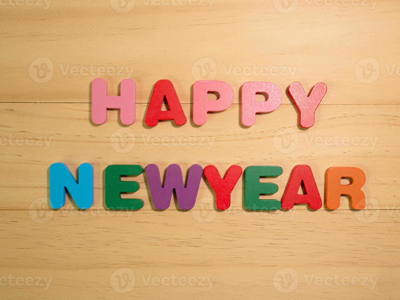 The happy new year on  wood texture for background concept photo