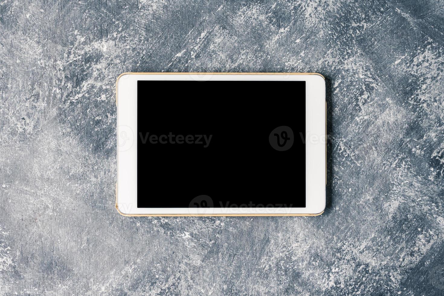 White tablet touch computer gadget with touch blank black screen on grunge background. photo