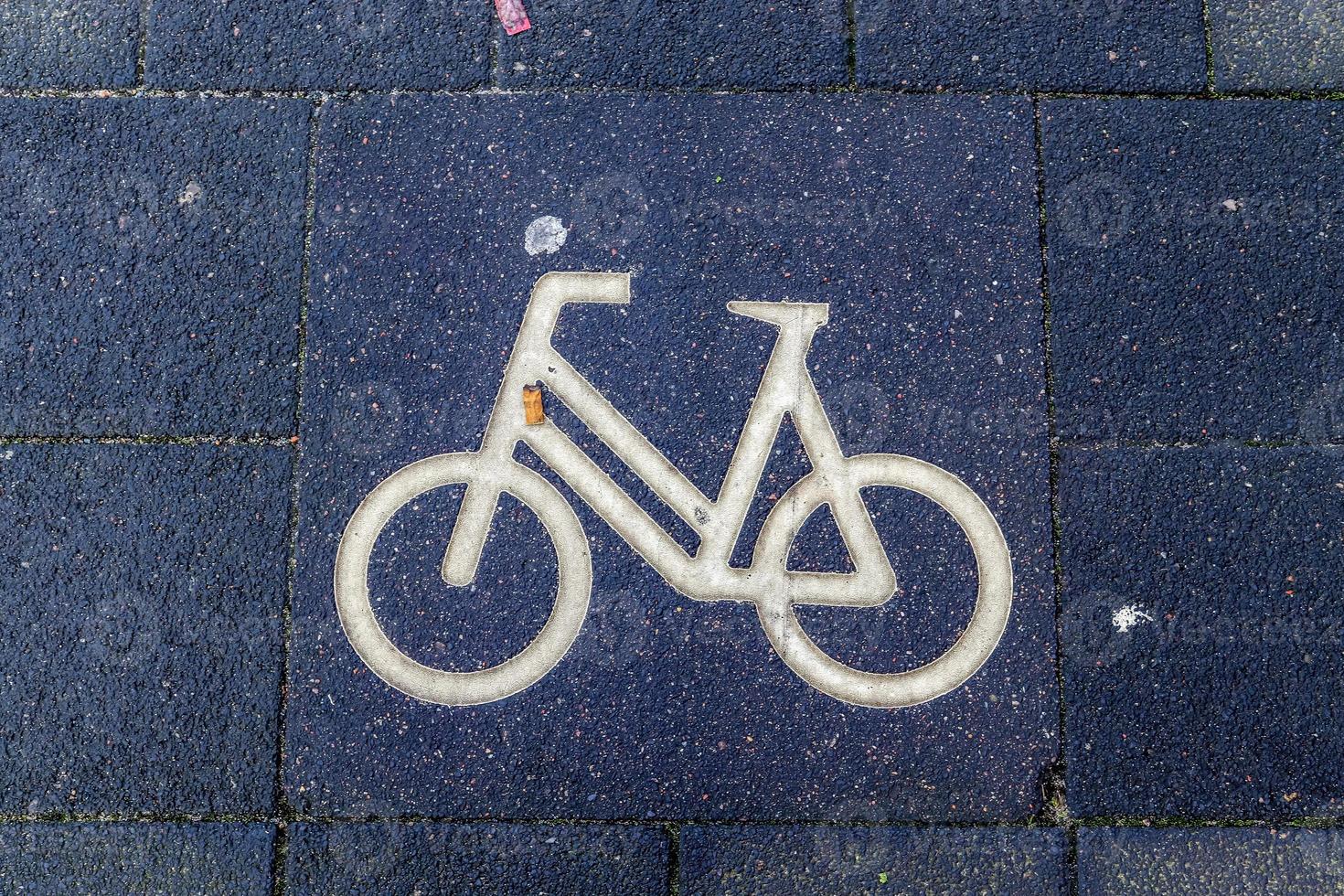 Painted bicycle signs on asphalt found in the city streets of Germany. photo