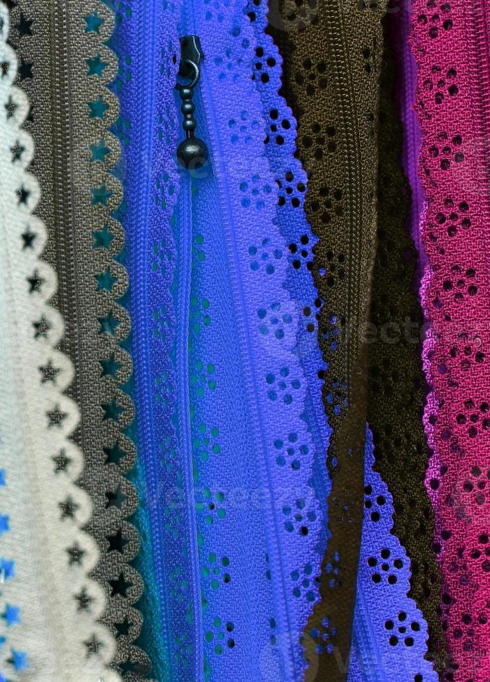 Detailed close up view on samples of cloth and fabrics in different colors found at a fabrics market photo