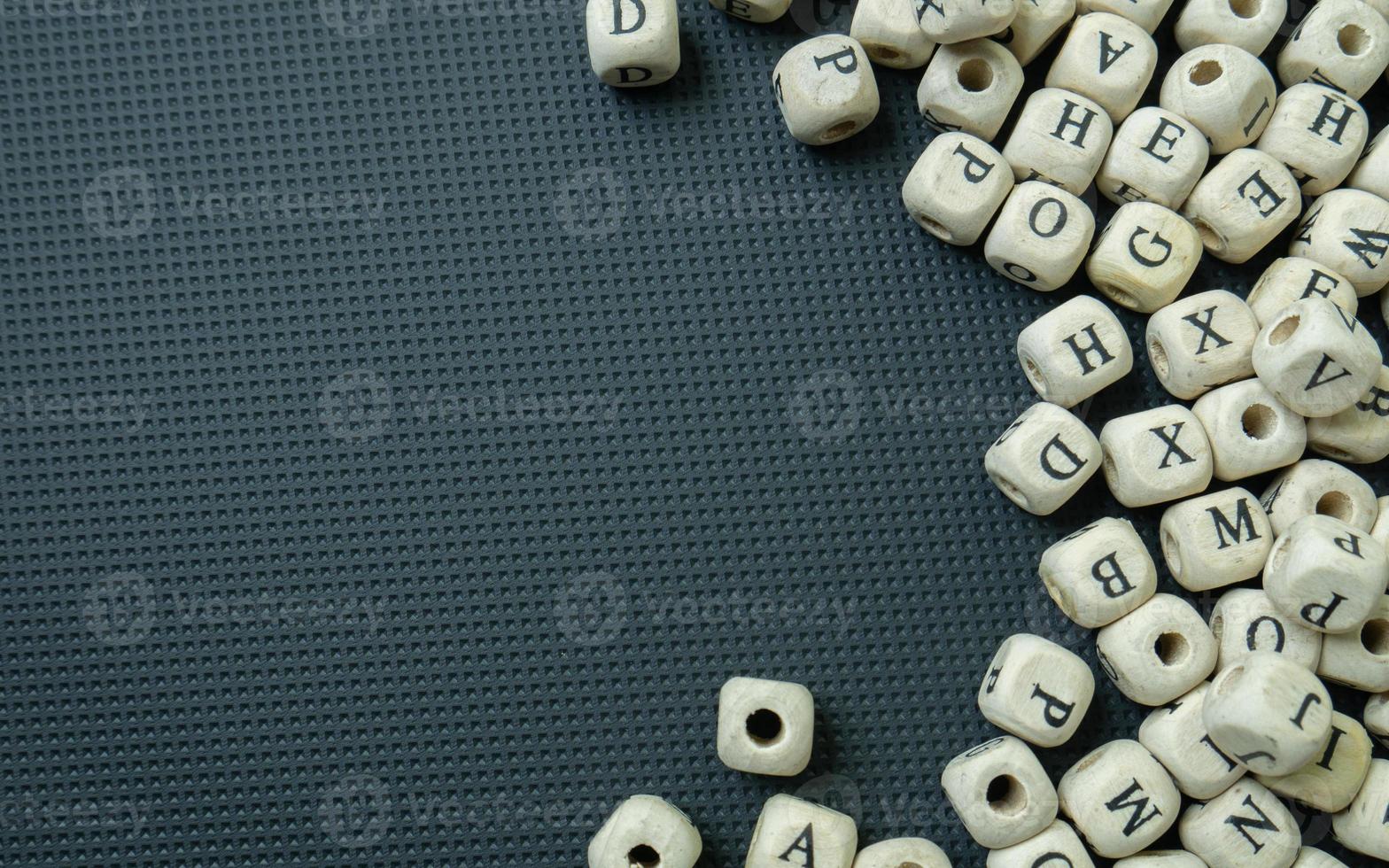 The alphabet wood cube on black background  for  education concept photo