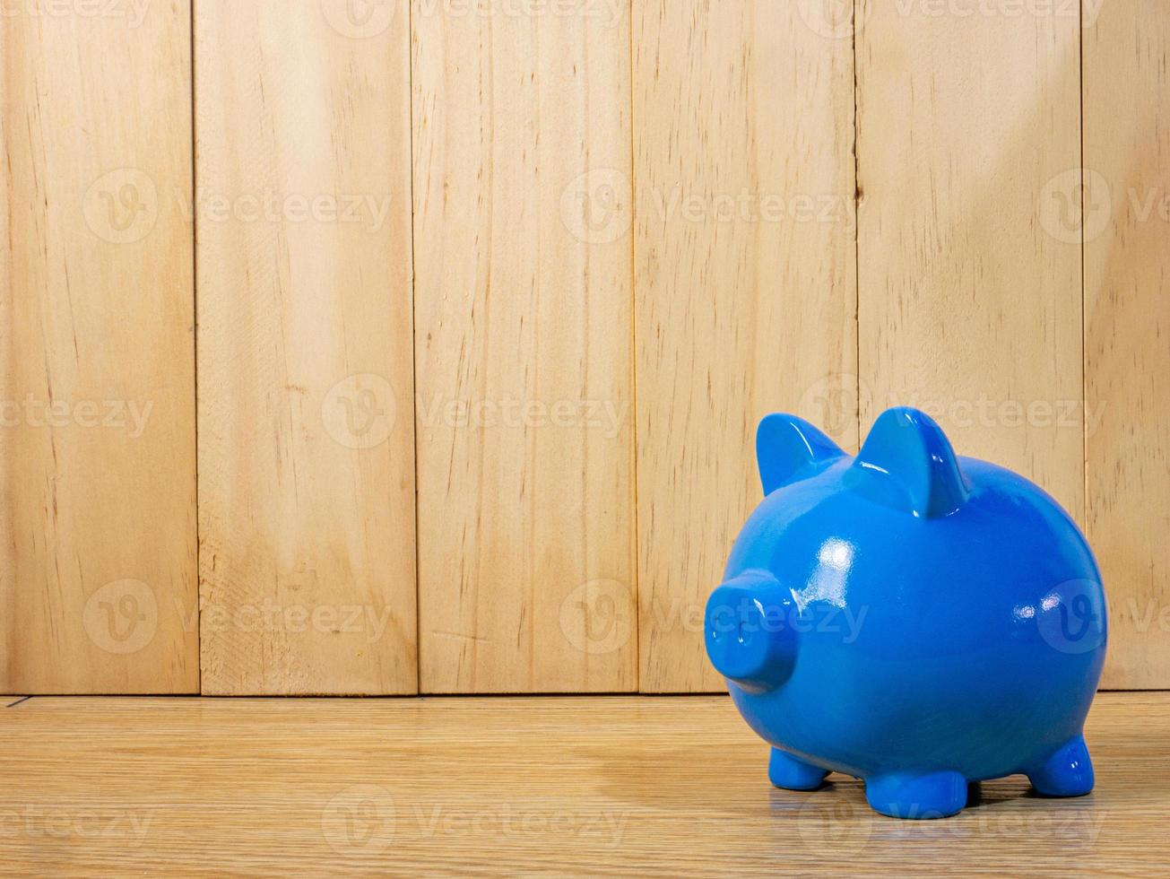 The piggy bank on wood table for saving or business background concept photo