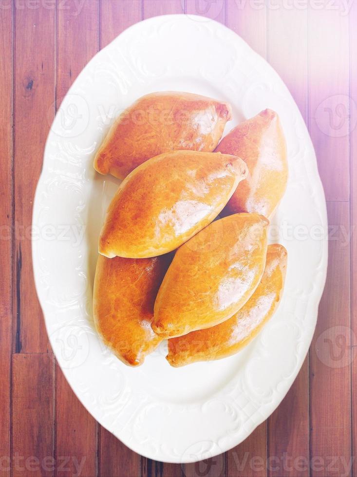 Bread in wood table. Sun. Grandma foods. photo