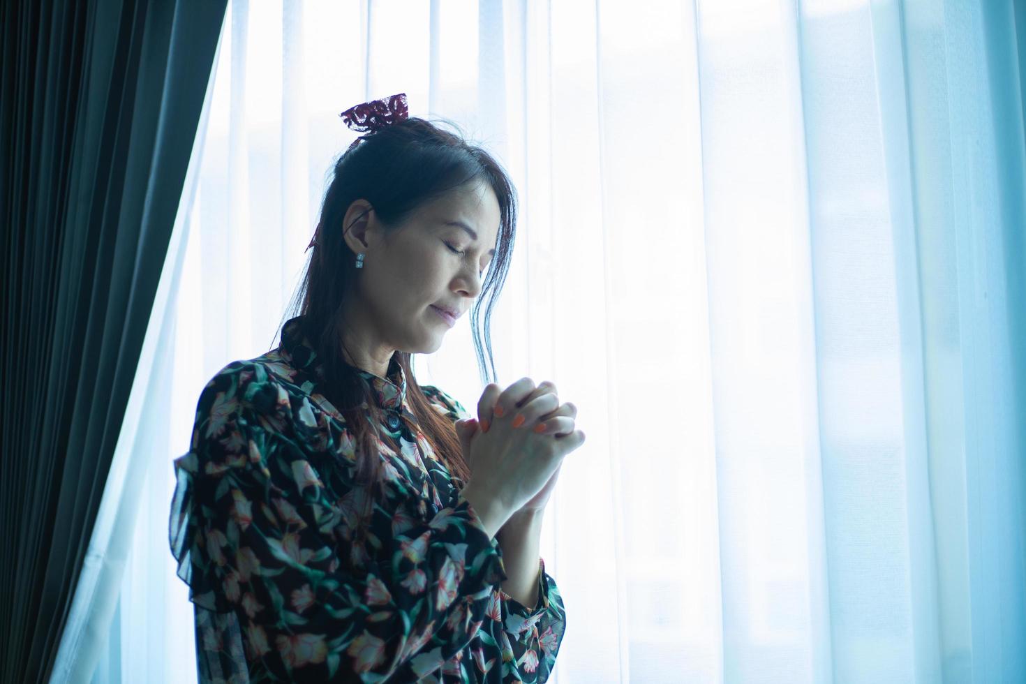 Woman hands praying to god wishing have a better life. photo