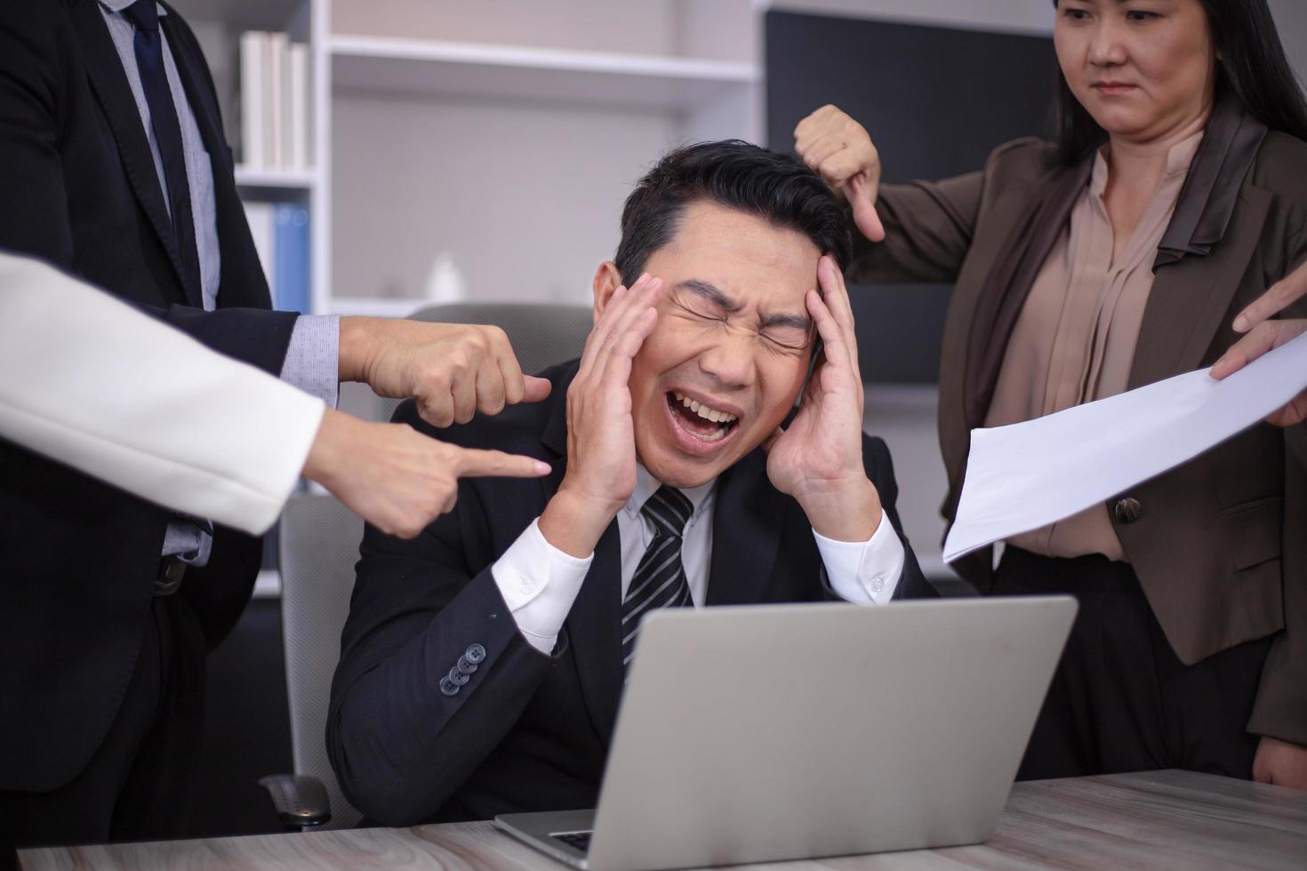 Businessman is stressed about working with no one to help. photo