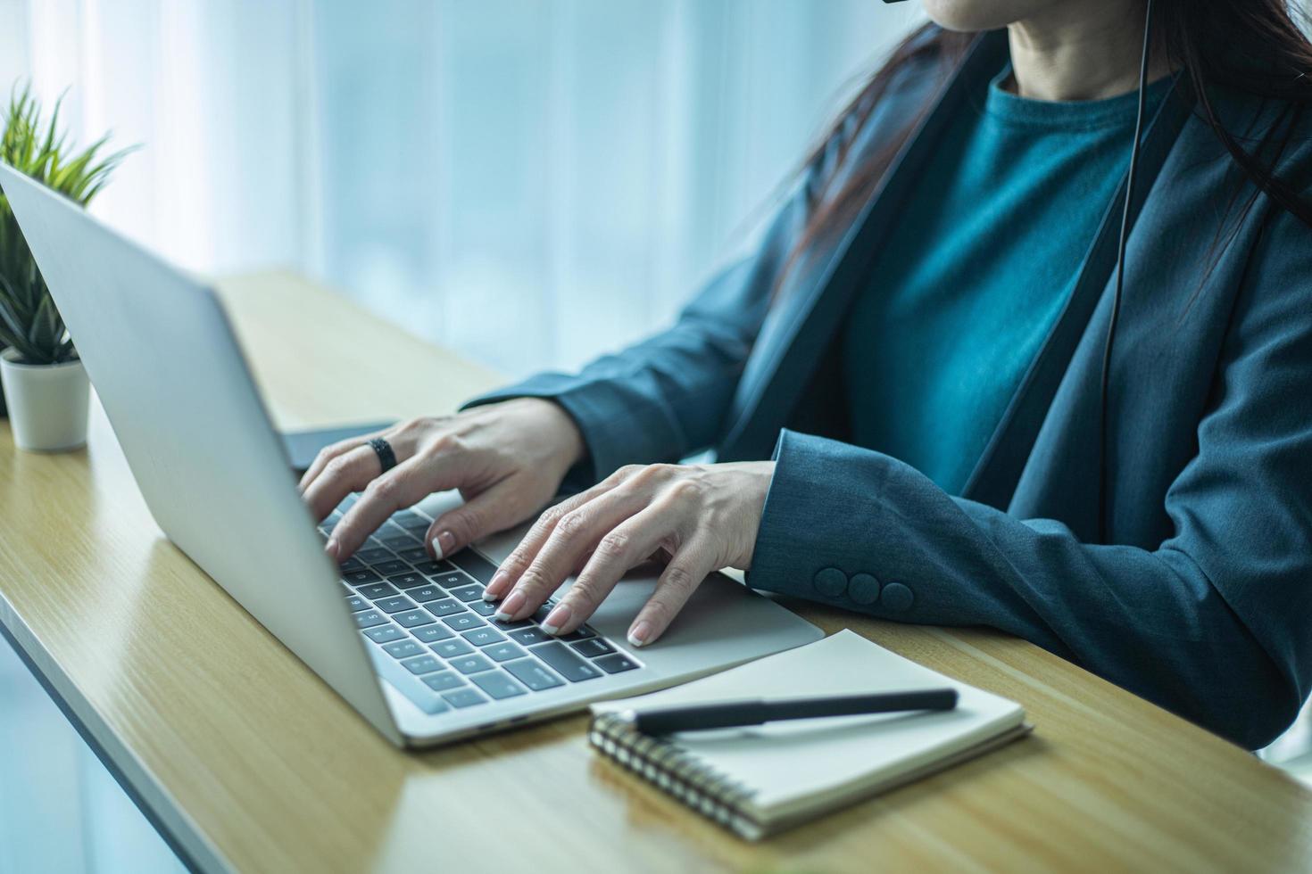 Woman hands typing on computer keyboard closeup, businesswoman using laptop at home. photo