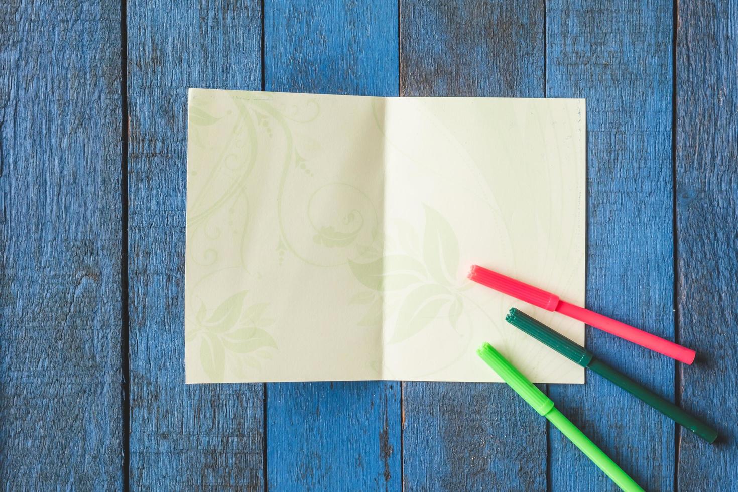 Top view of greeting card on wooden table background. photo