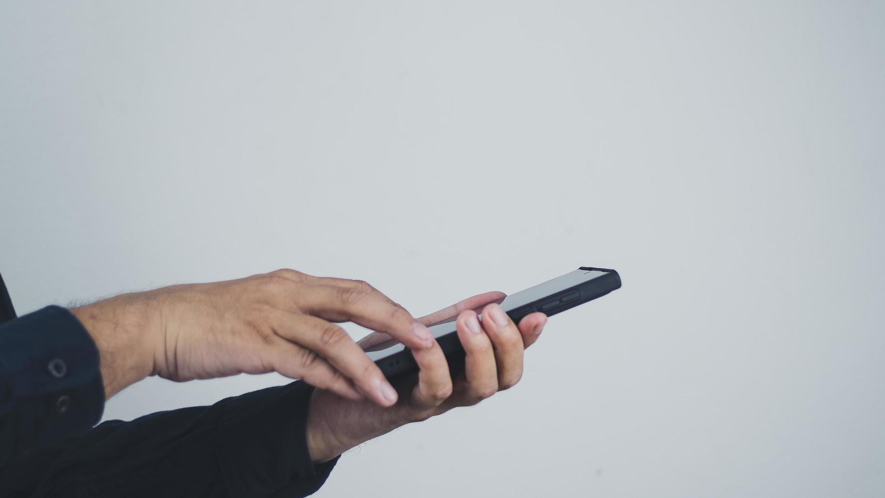 Social media technology concept, men's hands using smartphones to login social media, work from home or do online marketing. business and finance photo