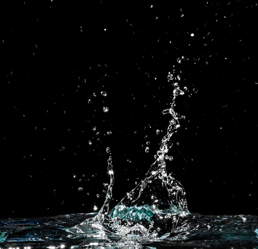 Water splash isolated on black background photo