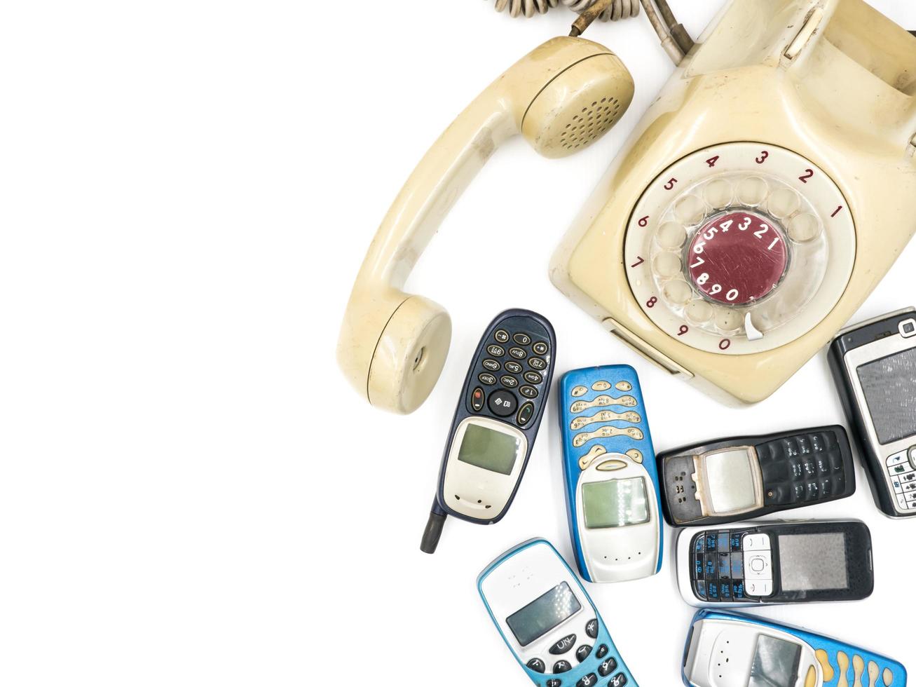 Old telephone and moblie phone on white background photo