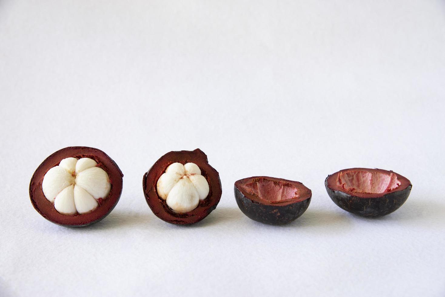 Mangosteen Thai popular fruits - a tropical fruit with sweet juicy white segments of flesh inside a thick reddish-brown rind. photo