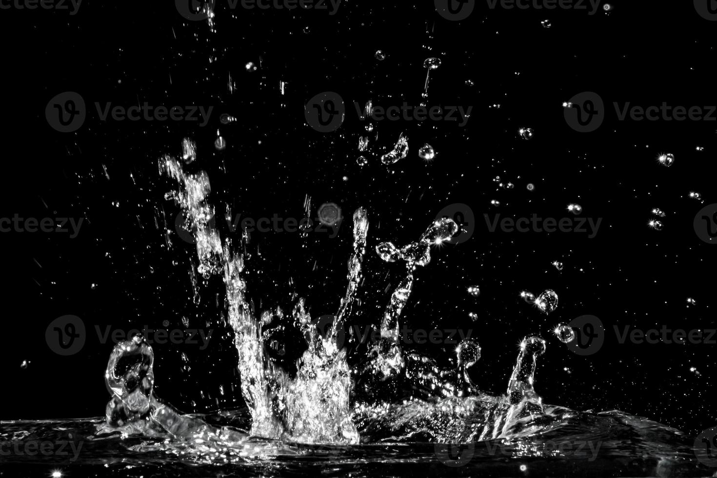 Water splash isolated on black background photo