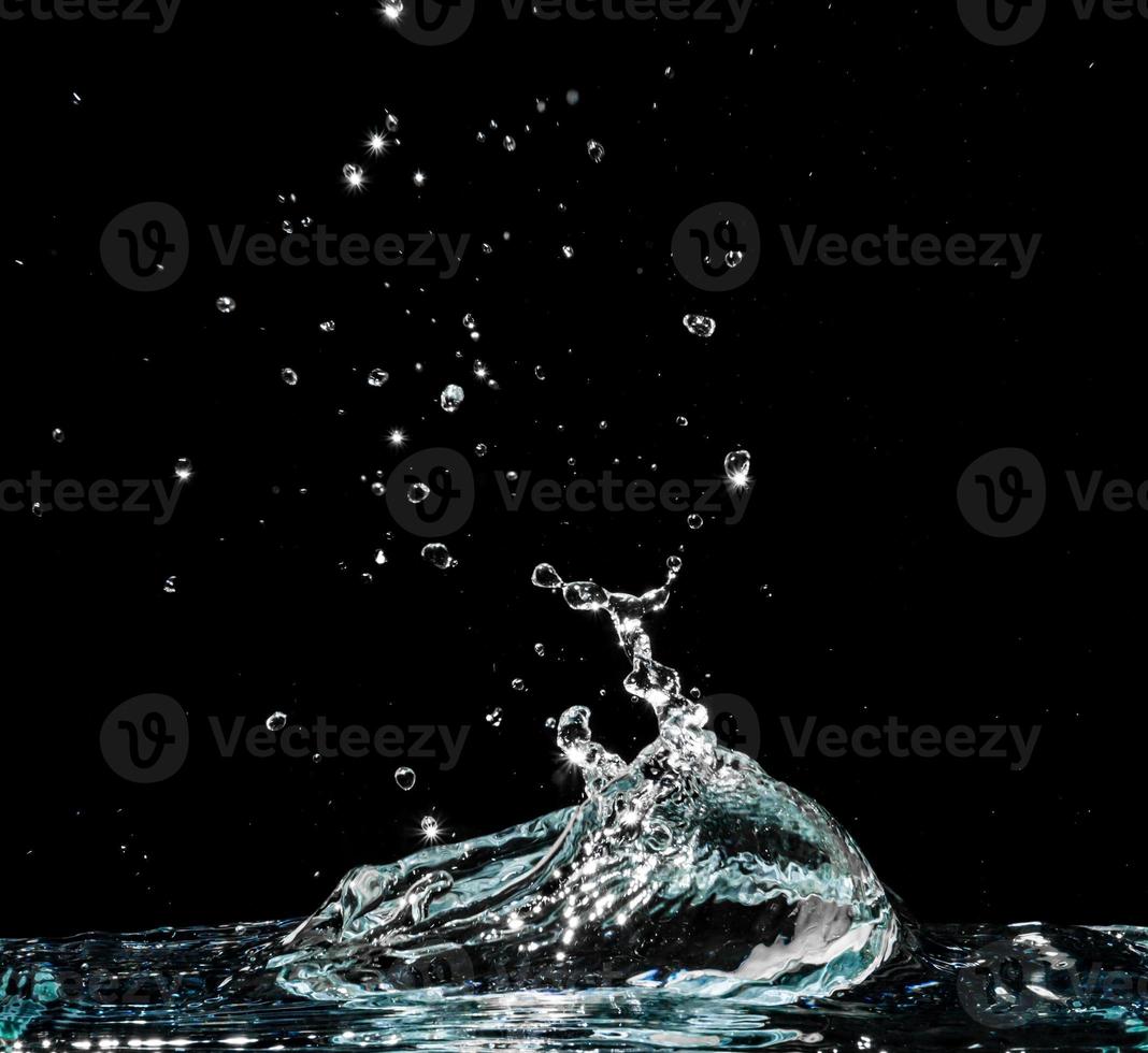 Water splash isolated on black background photo