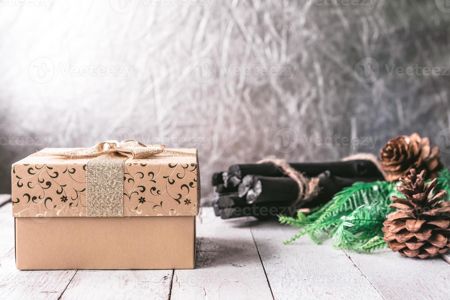 Gift box with Christmas decoration on wooden table background photo