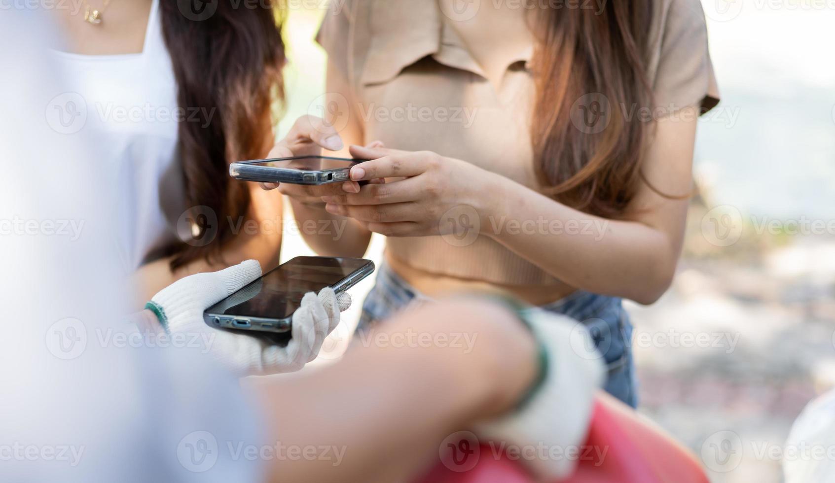 Asian women get contact numbers from Asian male auto mechanics after fixing the car engine problem and QR code scan to pay for fixing vehicle service. Car repair, and maintenance concept. photo
