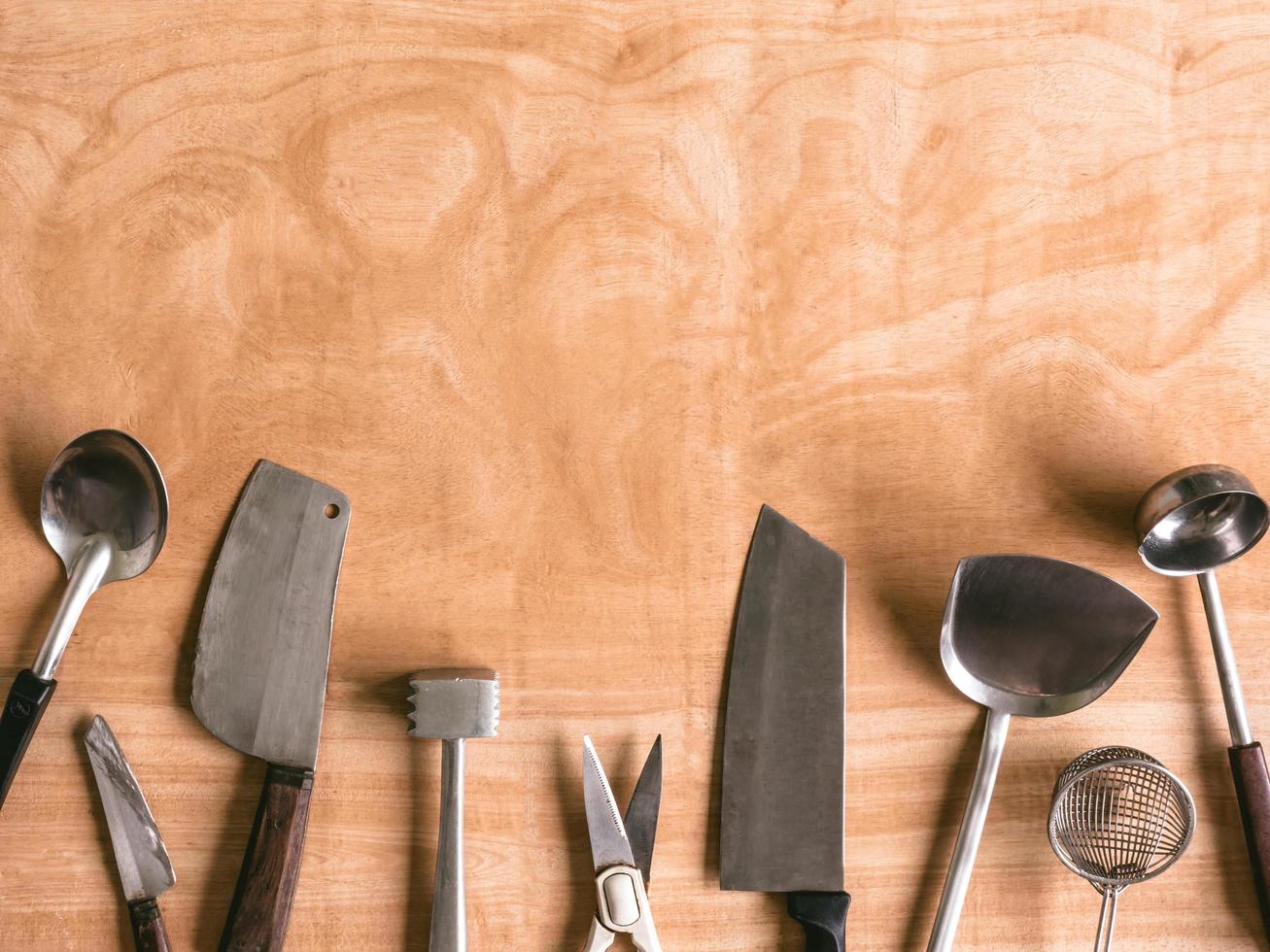 Kitchen utensils on wooden table background. photo