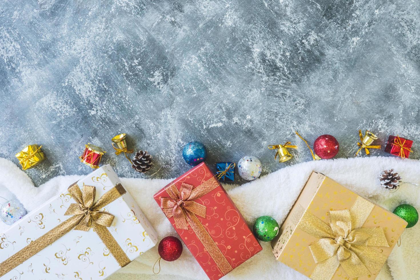 Top view of Gift boxes with Christmas decoration on gray grunge background. photo