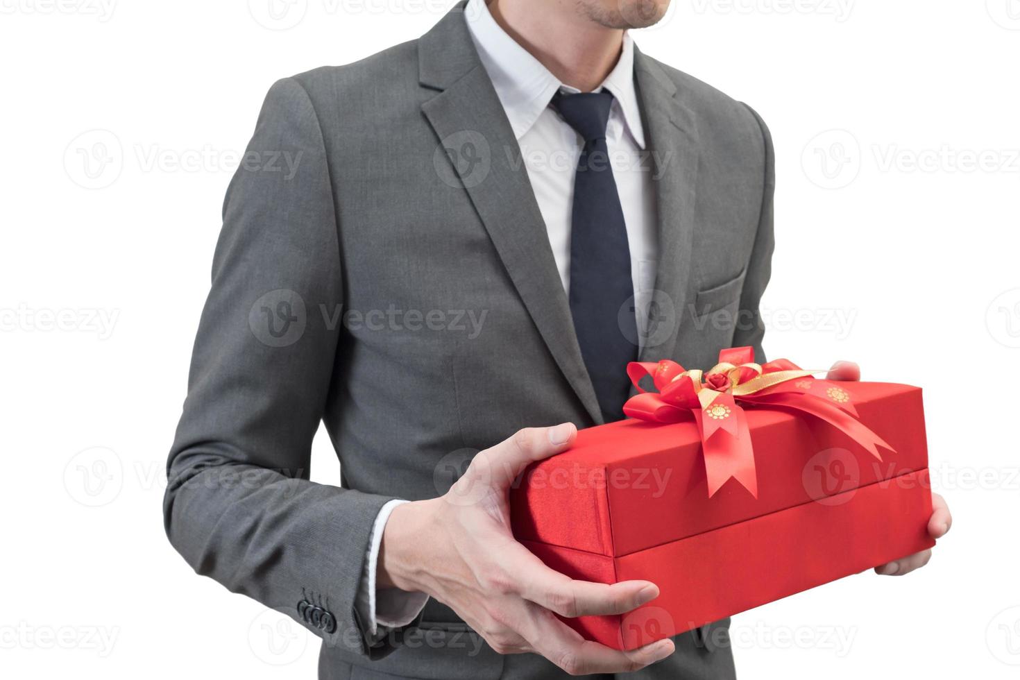 Businessman holding a red giftbox  isolated on white background. photo