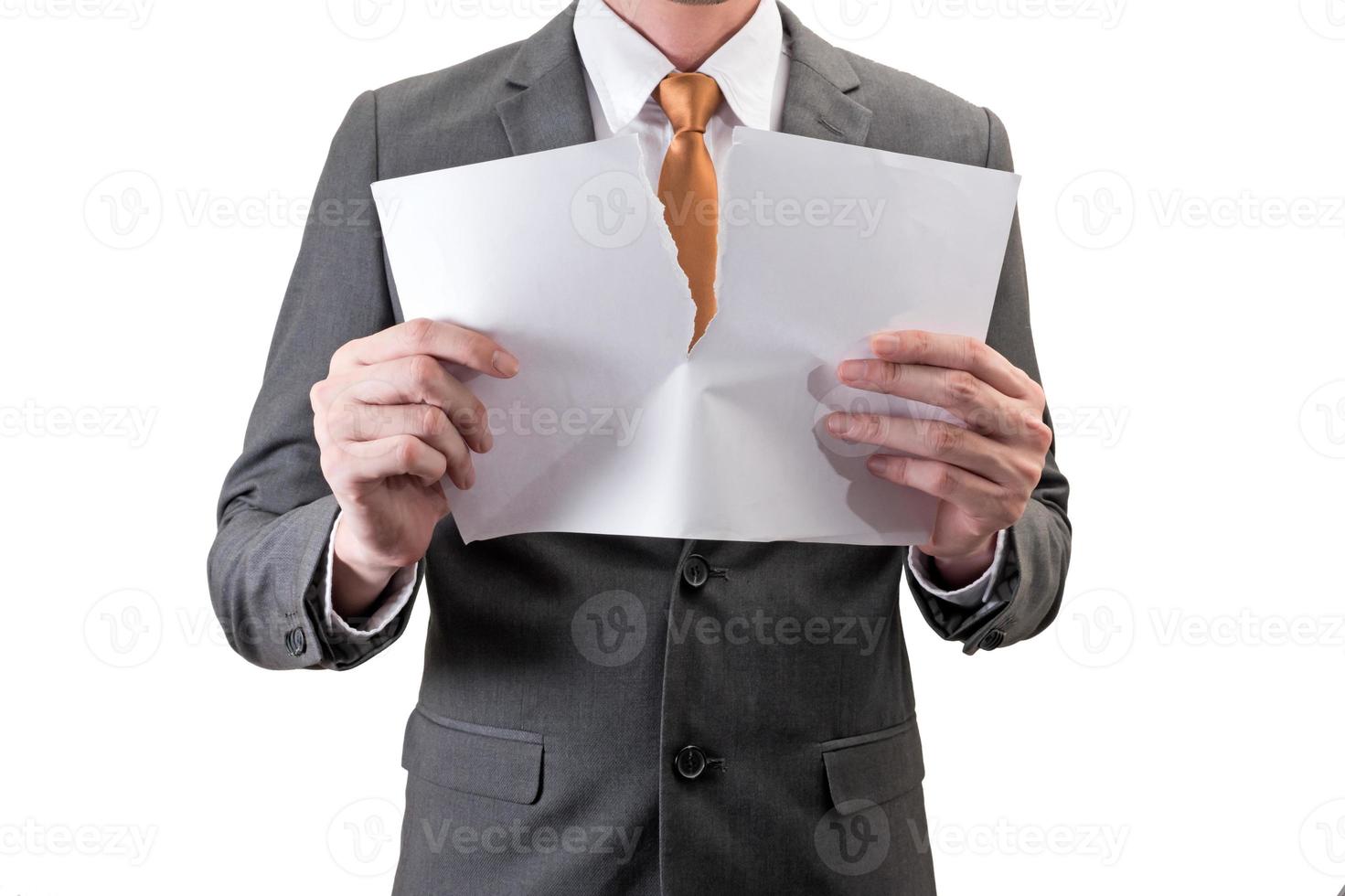 Businessman tearing white paper isolated on white background. photo