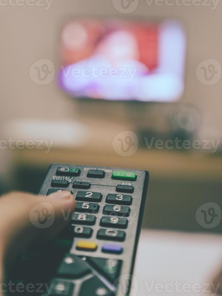 Television remote control in hand.vintage filter photo