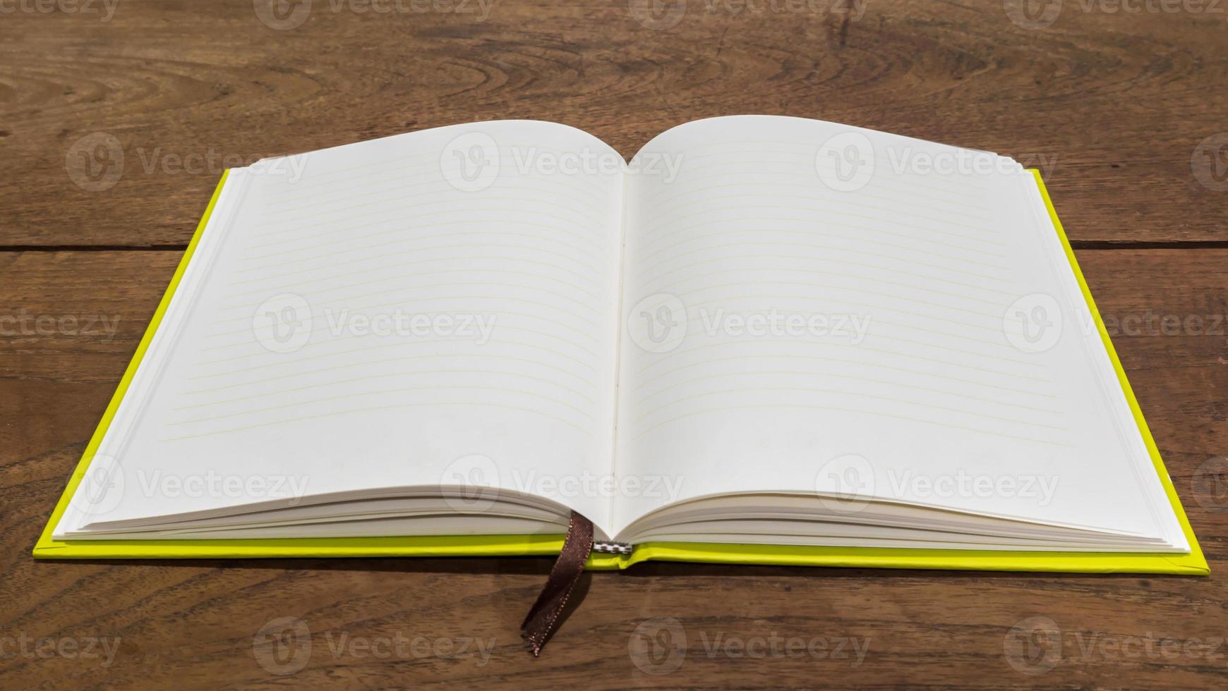 Blank notebook  on wooden table. photo