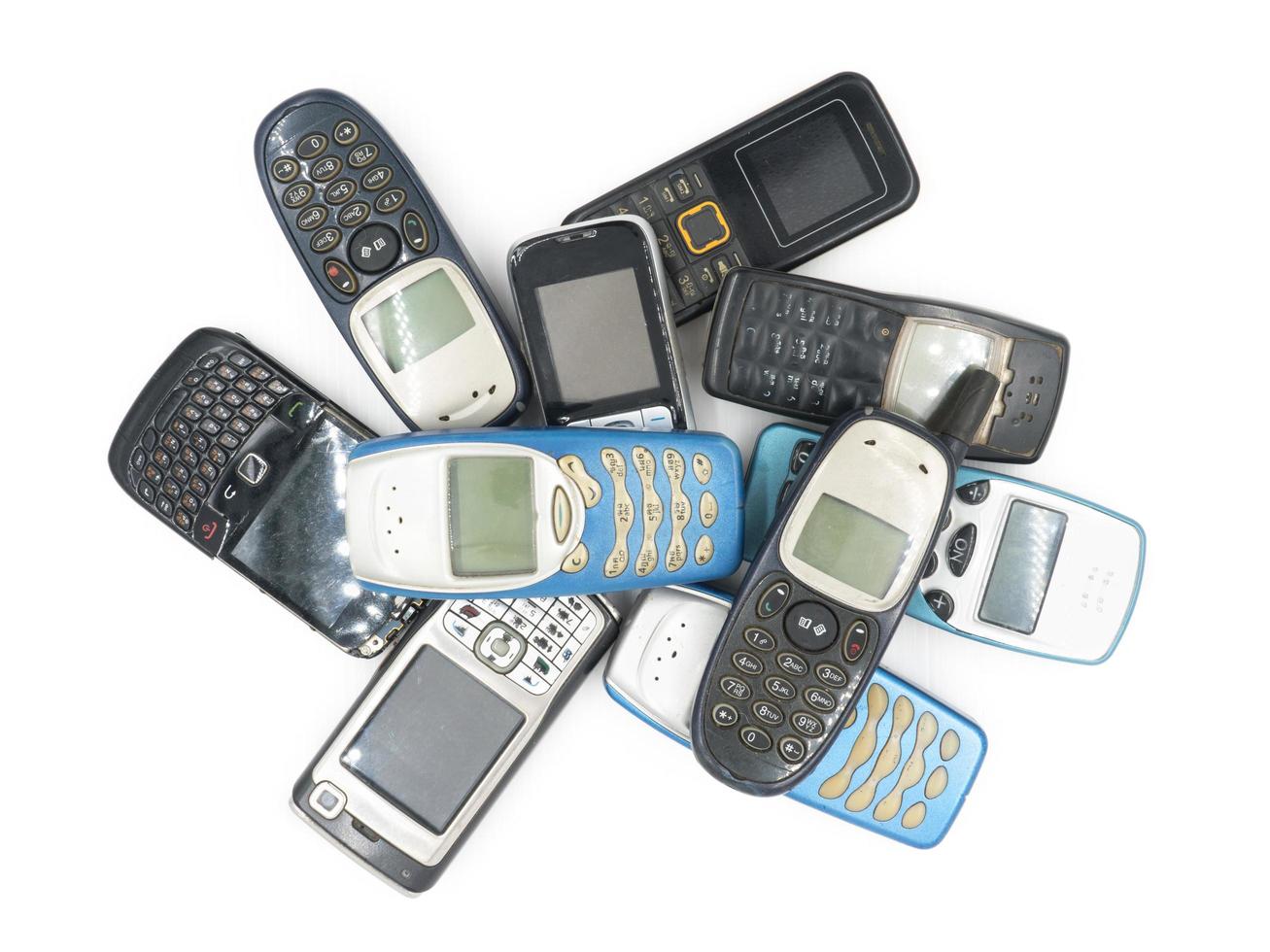 Top view of Old mobile phones on white background photo