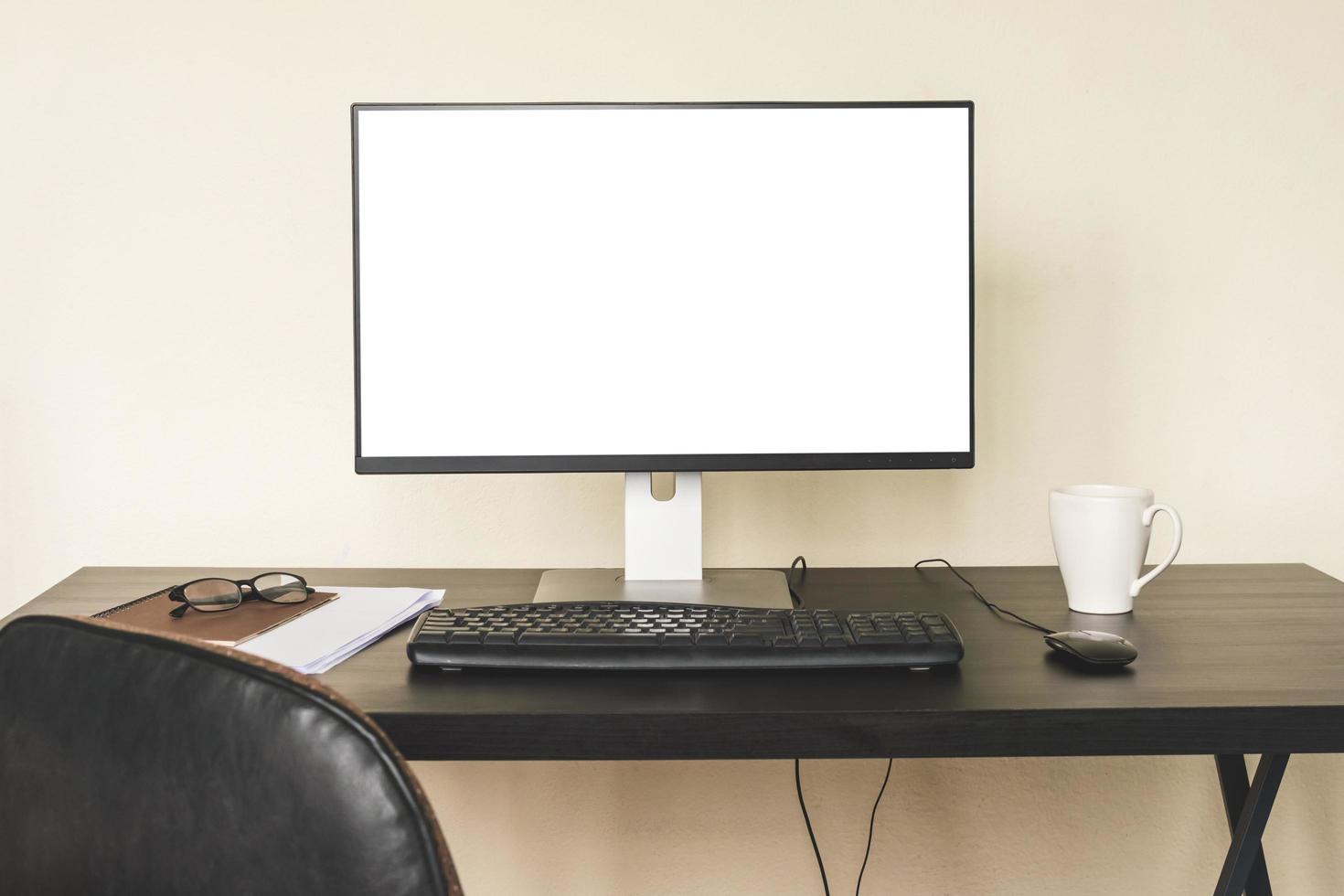 Computer with white screen on the desk. photo