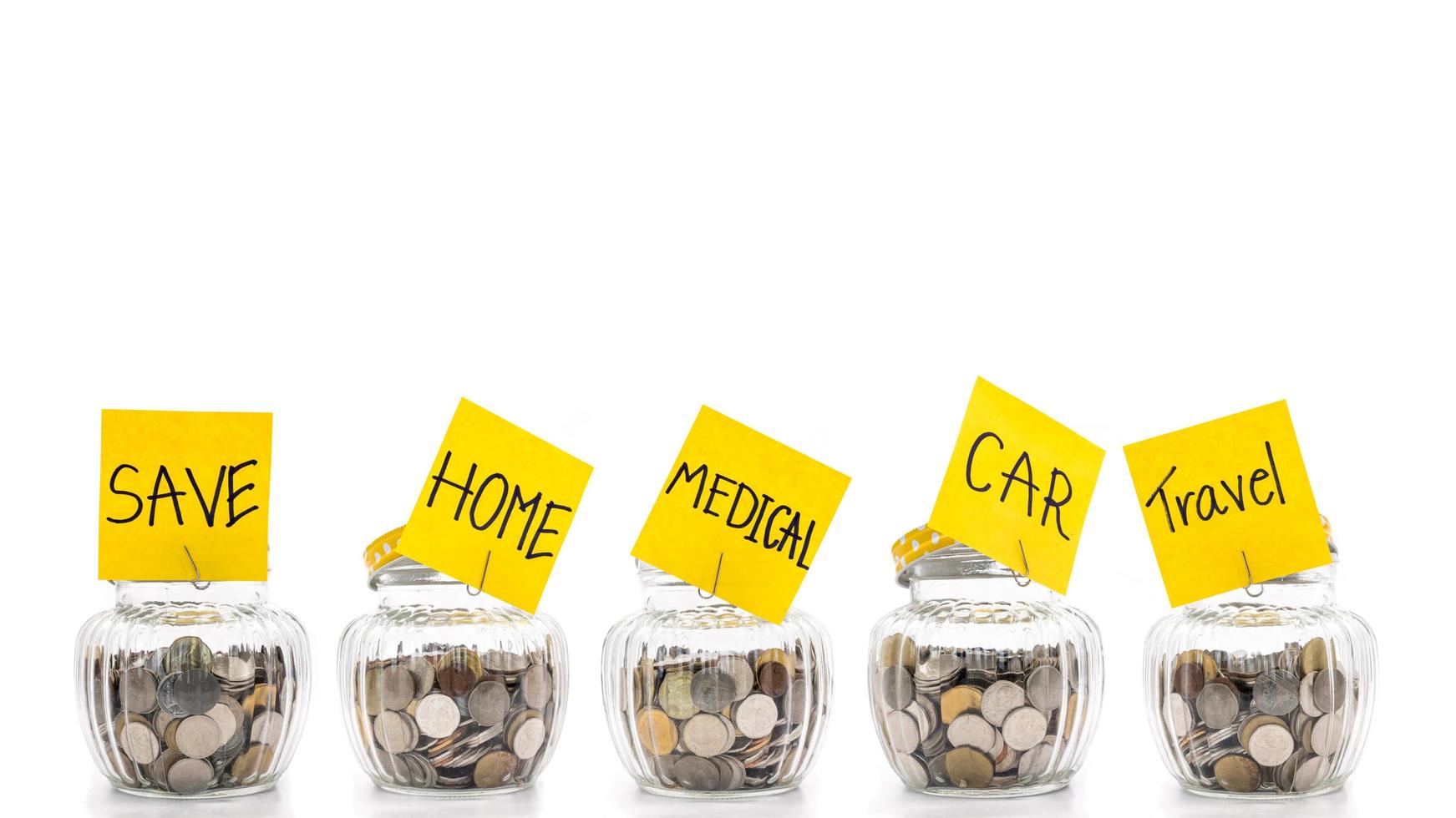 Coins in many glass bottles on white background, saving money concept photo