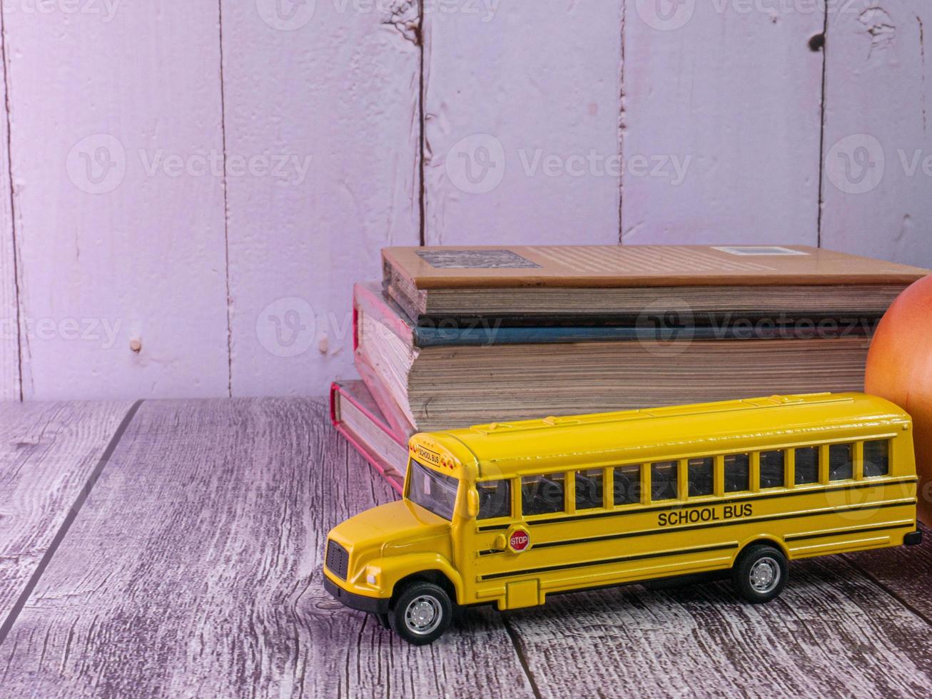 school bus on wood table for education concept photo