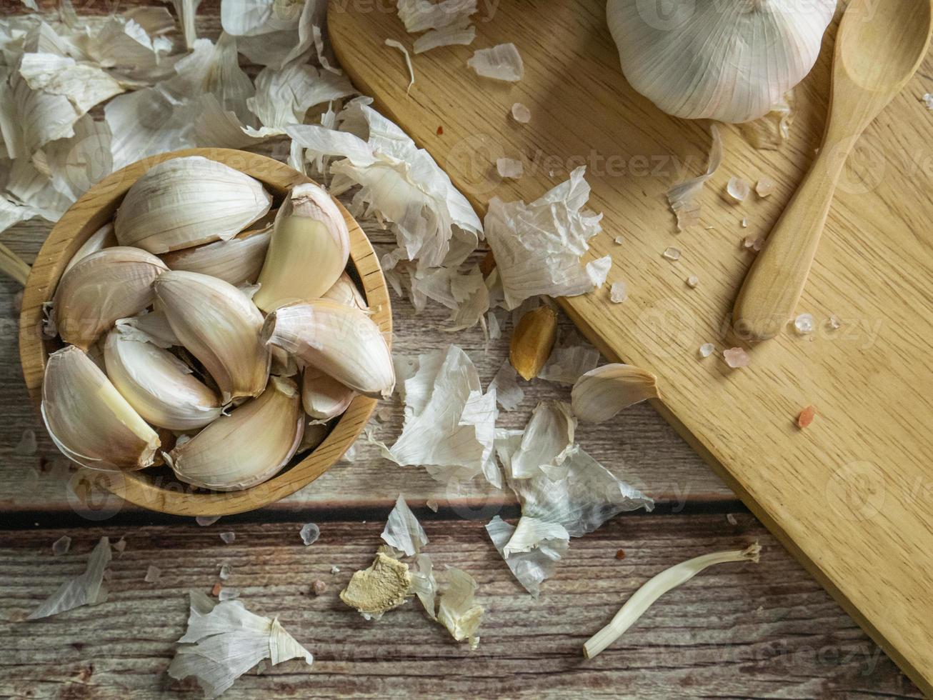 The garlic on wood table for food or cooking concept. photo