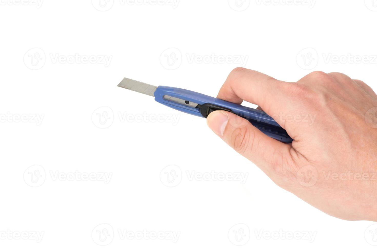 Hand holding cutter knife on white background. photo