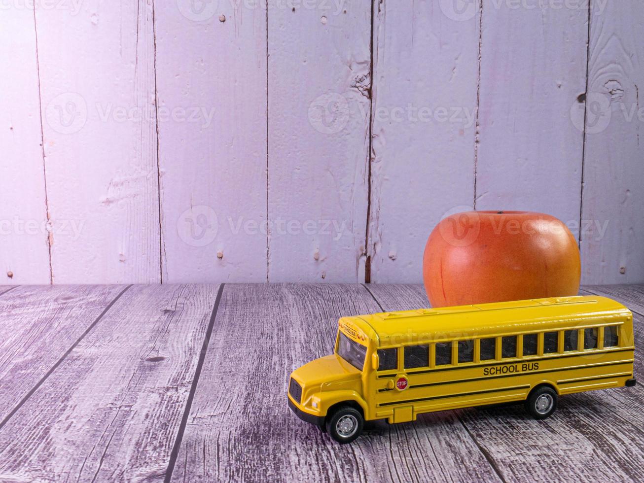 school bus on wood table for education concept photo