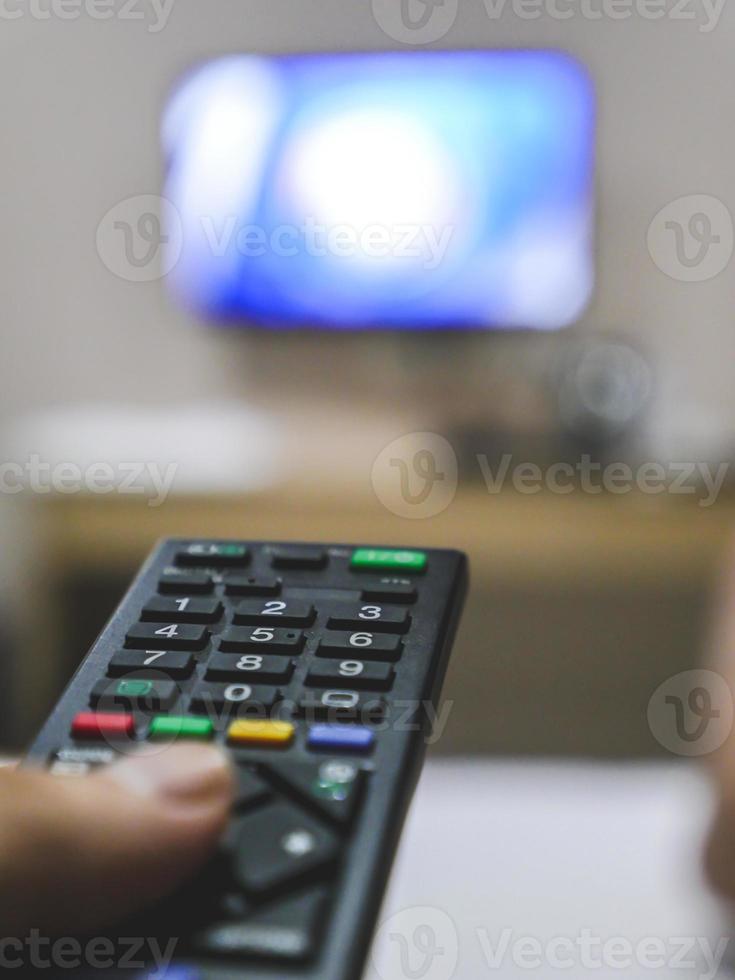 Television remote control in hand. photo