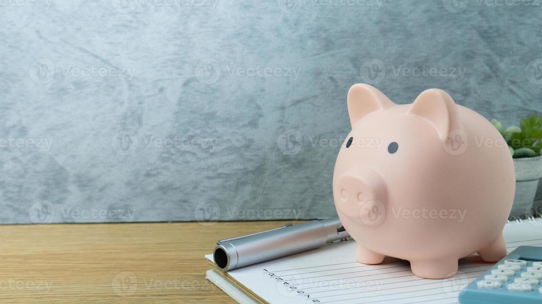 The piggy bank and blue calculator for saving money or business  concept photo