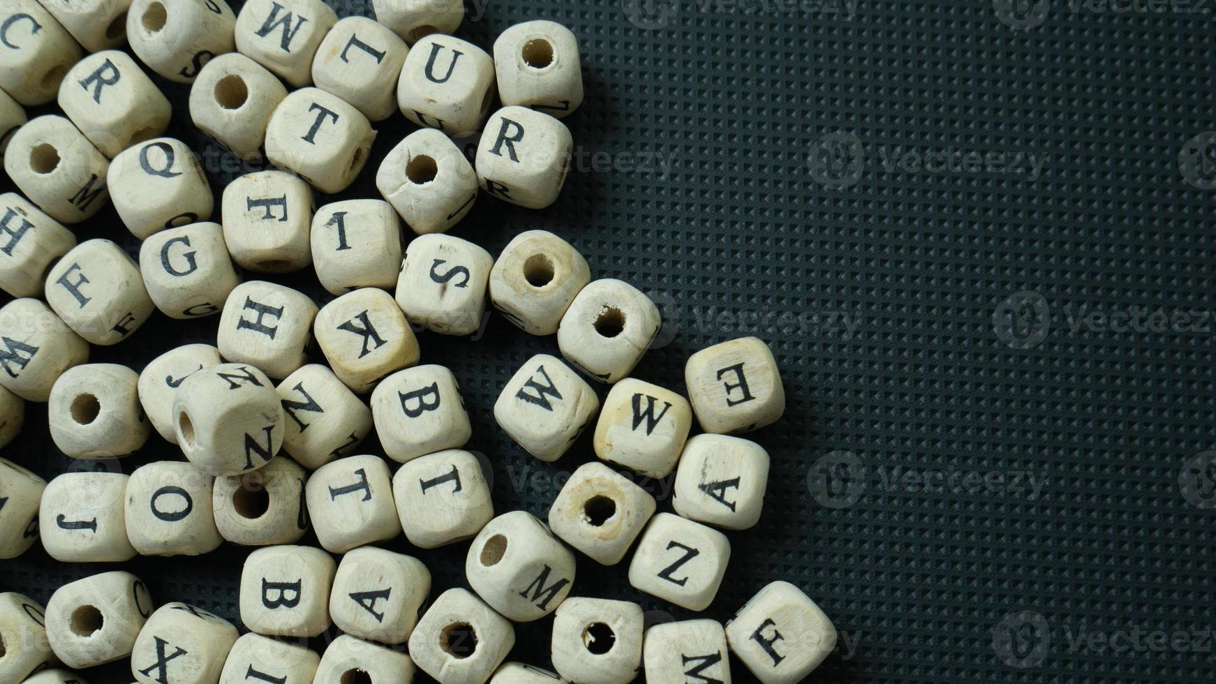The alphabet wood cube on black background  for  education concept photo