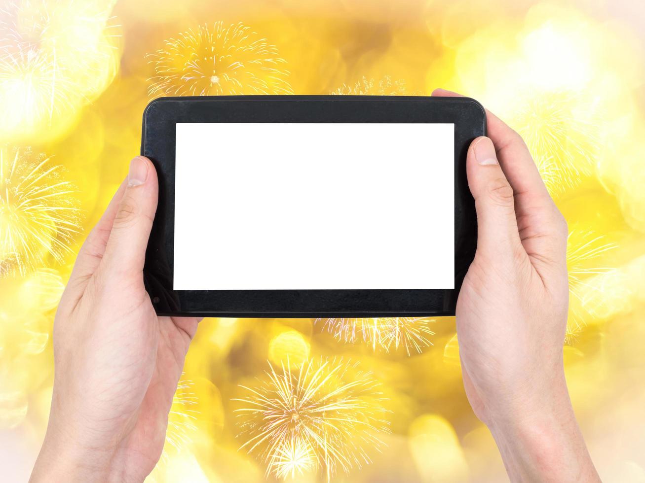 Male hand holding a tablet touch computer gadget with touch blank screen on bokeh lights and sparkle background. photo